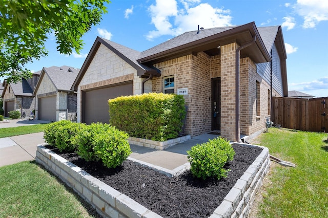 2619 Pinckney Ct, Forney, TX 75126 - view of front facade featuring an attached garage, brick siding, stone siding, roof with shingles, and concrete driveway