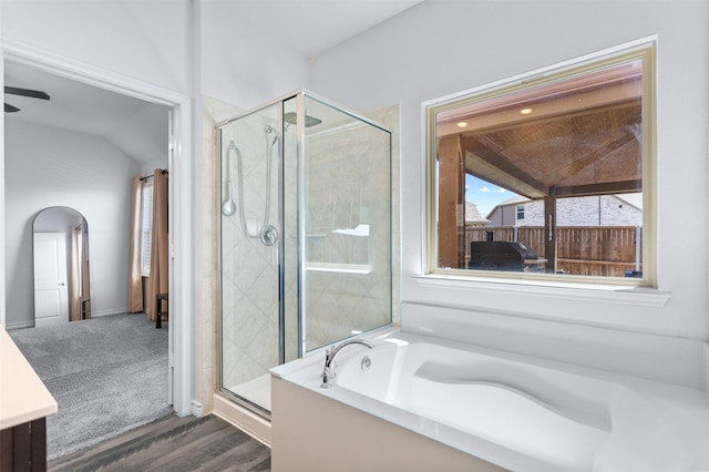 2619 Pinckney Ct, Forney, TX 75126 - bathroom with a stall shower, a bath, vanity, wood finished floors, and vaulted ceiling