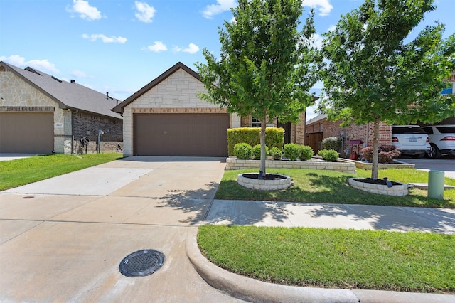 2619 Pinckney Ct, Forney, TX 75126 - view of front of property featuring an attached garage, concrete driveway, stone siding, and a front lawn