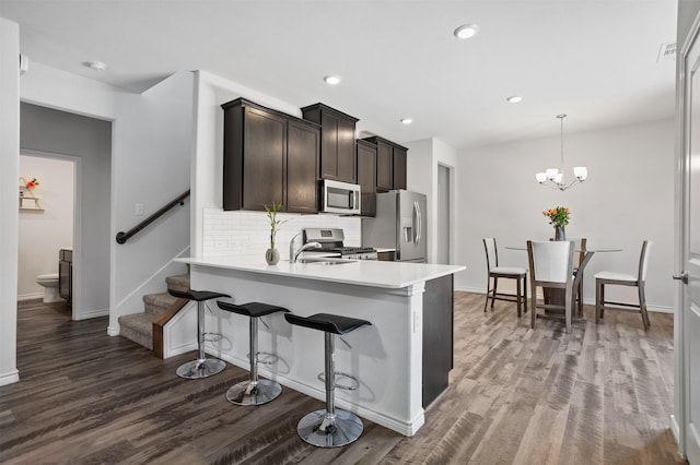 2619 Pinckney Ct, Forney, TX 75126 - kitchen with stainless steel appliances, dark wood-style floors, backsplash, light countertops, and recessed lighting