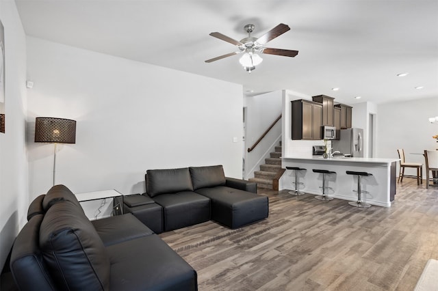 2619 Pinckney Ct, Forney, TX 75126 - living area featuring a ceiling fan, wood finished floors, stairs, and recessed lighting