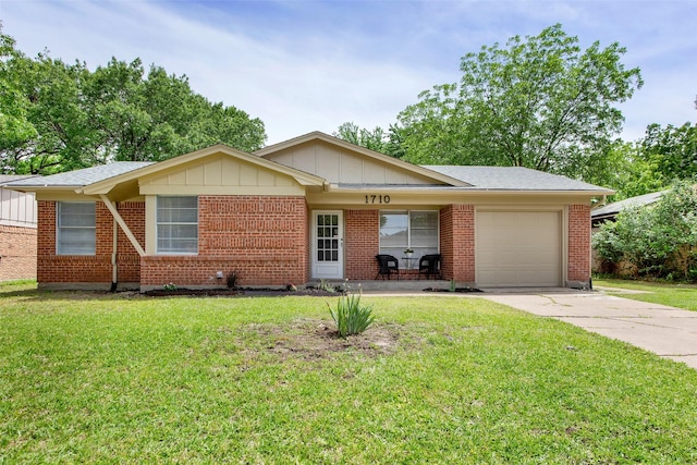 ranch-style house with a garage, driveway, a front yard, board and batten siding, and brick siding