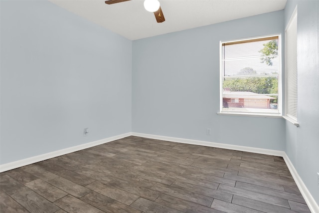spare room featuring ceiling fan, wood finished floors, and baseboards