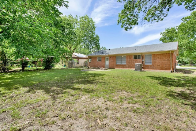 back of house with brick siding, central AC unit, and a patio area