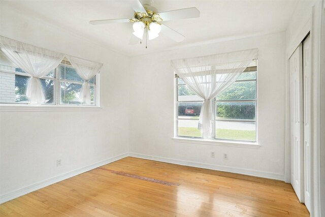4805 Ira St, Haltom City, TX 76117 - unfurnished room with healthy amount of natural light, light wood finished floors, baseboards, and ceiling fan