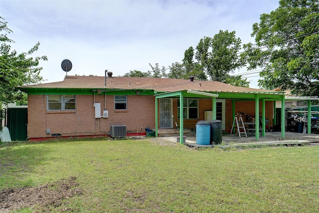 4805 Ira St, Haltom City, TX 76117 - back of property with a patio area, a yard, central AC, and brick siding