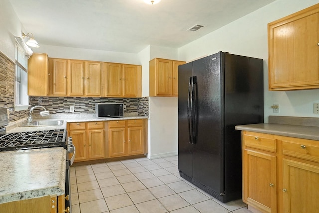 4805 Ira St, Haltom City, TX 76117 - kitchen featuring a sink, black appliances, decorative backsplash, light countertops, and light tile patterned floors