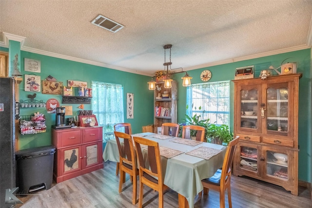 225 Field St, Clyde, TX 79510 - dining area with a textured ceiling, wood finished floors, and crown molding