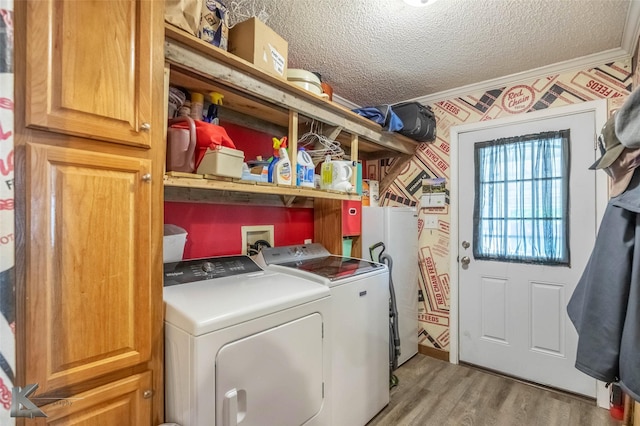 225 Field St, Clyde, TX 79510 - laundry area featuring washer and clothes dryer, light wood finished floors, a textured ceiling, and crown molding