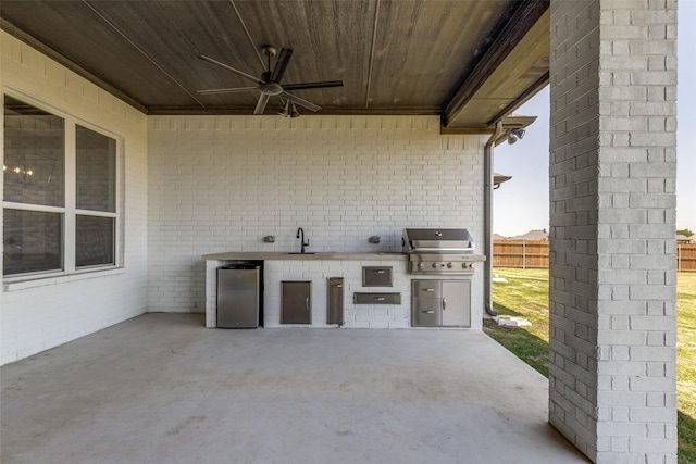 9104 Lazy Oak Dr, Justin, TX 76247 - view of patio / terrace with exterior kitchen, a sink, a ceiling fan, a grill, and fence