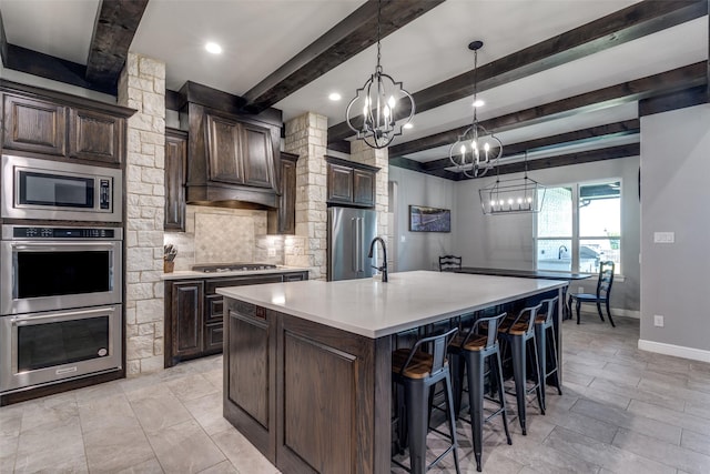 9104 Lazy Oak Dr, Justin, TX 76247 - kitchen with appliances with stainless steel finishes, a chandelier, decorative backsplash, light countertops, and dark brown cabinetry