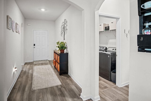 8213 Smokey Creek Pass, Fort Worth, TX 76179 - hallway with arched walkways, wood finished floors, washer and dryer, and baseboards