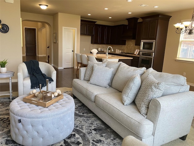 8740 Running River Ln, Fort Worth, TX 76131 - living area featuring arched walkways, baseboards, a chandelier, wood finished floors, and recessed lighting