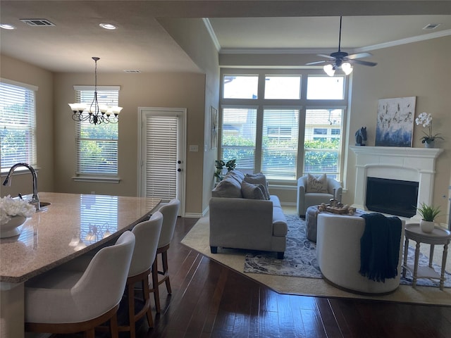 8740 Running River Ln, Fort Worth, TX 76131 - dining space with dark wood-type flooring, recessed lighting, ornamental molding, a ceiling fan, and a fireplace