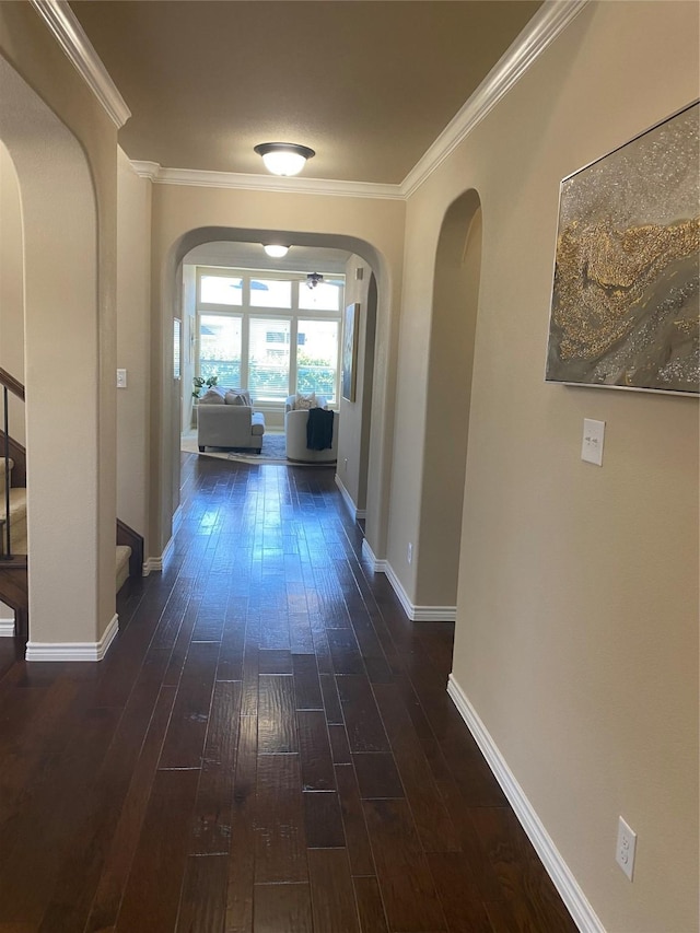 8740 Running River Ln, Fort Worth, TX 76131 - hallway featuring arched walkways, dark wood-type flooring, ornamental molding, stairs, and baseboards