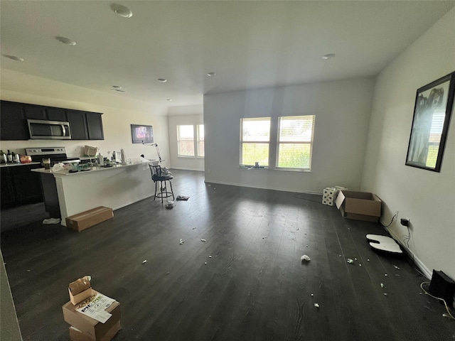 3303 Knoll Dr, Ennis, TX 75119 - unfurnished living room with dark wood-style flooring and baseboards