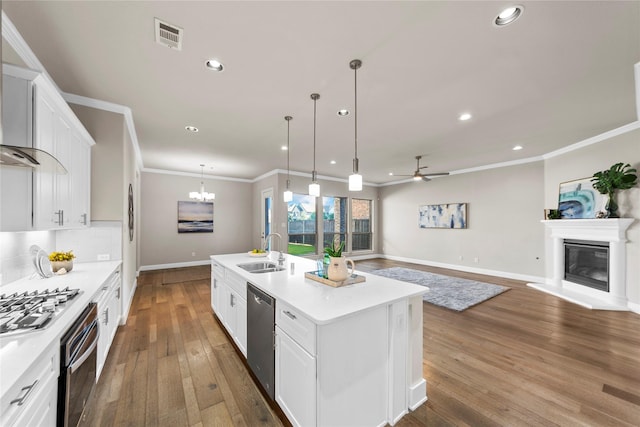 1608 Coventry Ct, Farmers Branch, TX 75234 - kitchen featuring stainless steel appliances, a sink, white cabinetry, ornamental molding, and recessed lighting