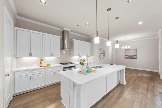 1608 Coventry Ct, Farmers Branch, TX 75234 - kitchen featuring wall chimney range hood, a sink, white cabinetry, decorative backsplash, and crown molding