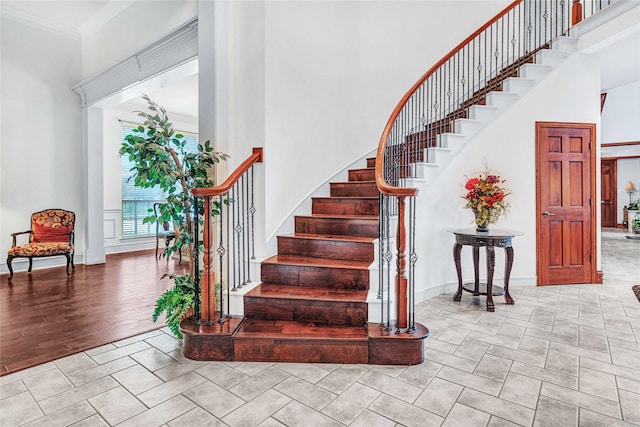11086 Tenison Ln, Frisco, TX 75033 - staircase featuring a high ceiling, ornamental molding, and baseboards
