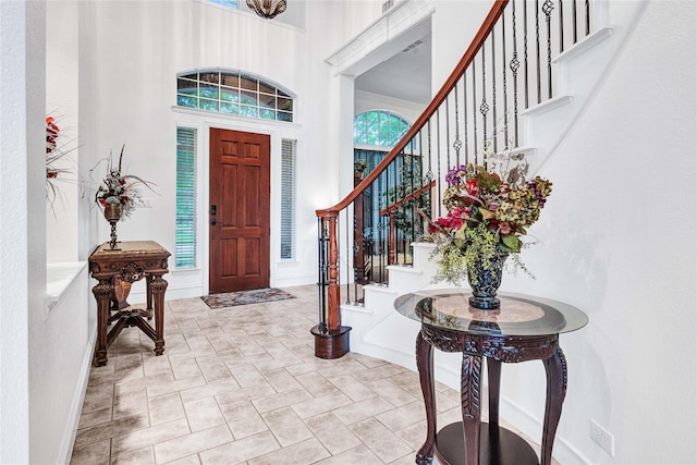 11086 Tenison Ln, Frisco, TX 75033 - entrance foyer with a towering ceiling, stairs, and baseboards