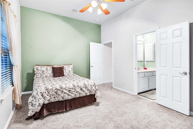 11086 Tenison Ln, Frisco, TX 75033 - carpeted bedroom with baseboards, connected bathroom, a ceiling fan, and a sink