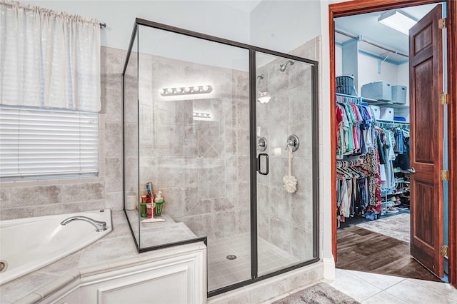 11086 Tenison Ln, Frisco, TX 75033 - full bath with a stall shower, a spacious closet, a bath, and tile patterned flooring
