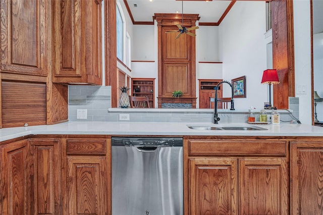 11086 Tenison Ln, Frisco, TX 75033 - kitchen with stainless steel dishwasher, a sink, brown cabinetry, decorative backsplash, and crown molding