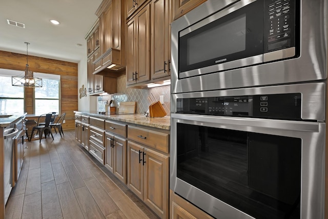 149 Deats Farm Ct, Azle, TX 76020 - kitchen featuring stainless steel appliances, wood finished floors, tasteful backsplash, light stone counters, and recessed lighting