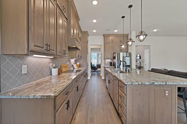 149 Deats Farm Ct, Azle, TX 76020 - kitchen featuring a sink, appliances with stainless steel finishes, a kitchen bar, light wood-type flooring, and decorative backsplash