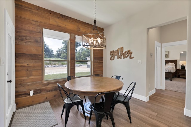 149 Deats Farm Ct, Azle, TX 76020 - dining area with a chandelier, wood walls, light wood finished floors, and baseboards