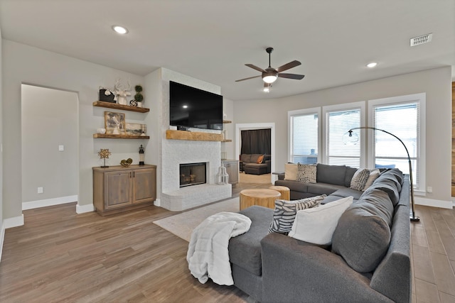 149 Deats Farm Ct, Azle, TX 76020 - living room with ceiling fan, light wood-style floors, a brick fireplace, baseboards, and recessed lighting