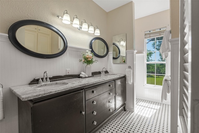 561 Farms Rd, New Hope, TX 75071 - bathroom featuring double vanity and a wainscoted wall