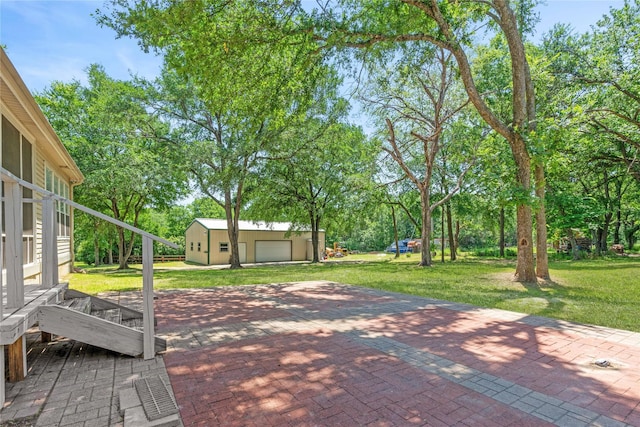 561 Farms Rd, New Hope, TX 75071 - view of patio featuring a detached garage, an outdoor structure, and view of scattered trees