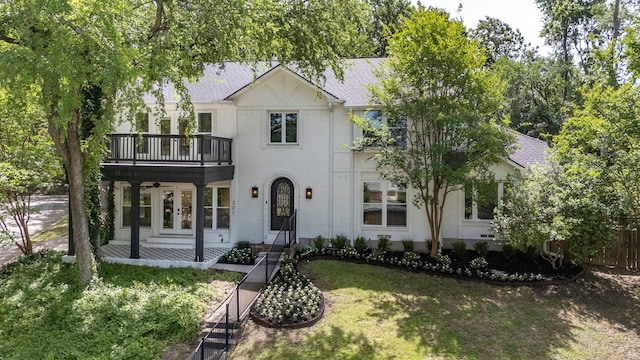 201 Forest Trce, Rockwall, TX 75087 - view of front of home featuring a balcony, french doors, stucco siding, and ceiling fan