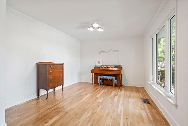 201 Forest Trce, Rockwall, TX 75087 - living area with light wood-type flooring, healthy amount of natural light, ornamental molding, and baseboards