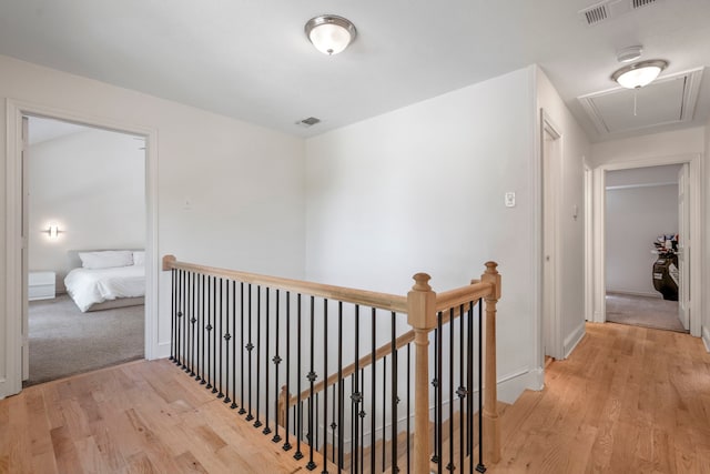 201 Forest Trce, Rockwall, TX 75087 - hall featuring attic access, an upstairs landing, light wood-style floors, and baseboards