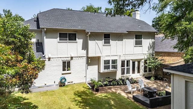 201 Forest Trce, Rockwall, TX 75087 - back of house featuring an outdoor fire pit, a chimney, a yard, and roof with shingles