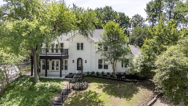 201 Forest Trce, Rockwall, TX 75087 - view of front of property with a balcony, a front yard, a shingled roof, and stucco siding