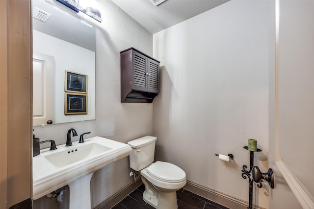 4944 Sage Hill Dr, Carrollton, TX 75010 - bathroom featuring toilet, wood tiled floors, and a sink
