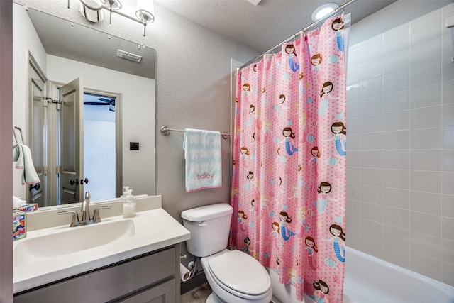 4944 Sage Hill Dr, Carrollton, TX 75010 - full bathroom featuring toilet, shower / bath combo with shower curtain, vanity, a textured wall, and a textured ceiling