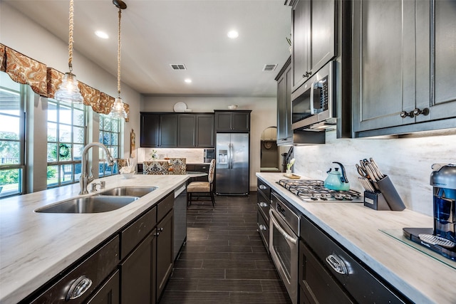 4944 Sage Hill Dr, Carrollton, TX 75010 - kitchen featuring stainless steel appliances, a sink, light countertops, backsplash, and recessed lighting