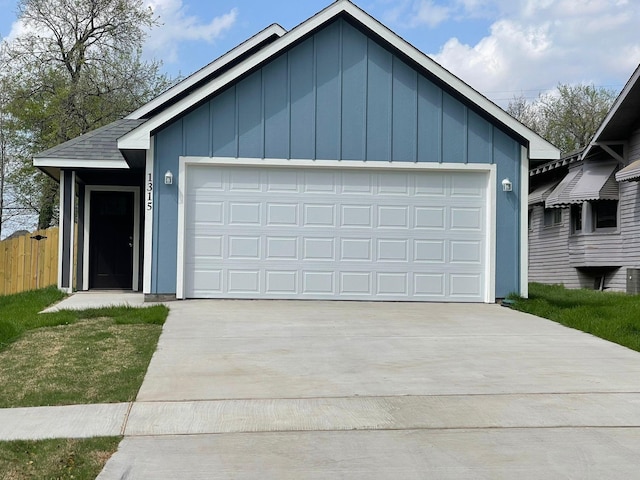 1315 W Gandy St, Denison, TX 75020 - view of front of home featuring board and batten siding, fence, and concrete driveway