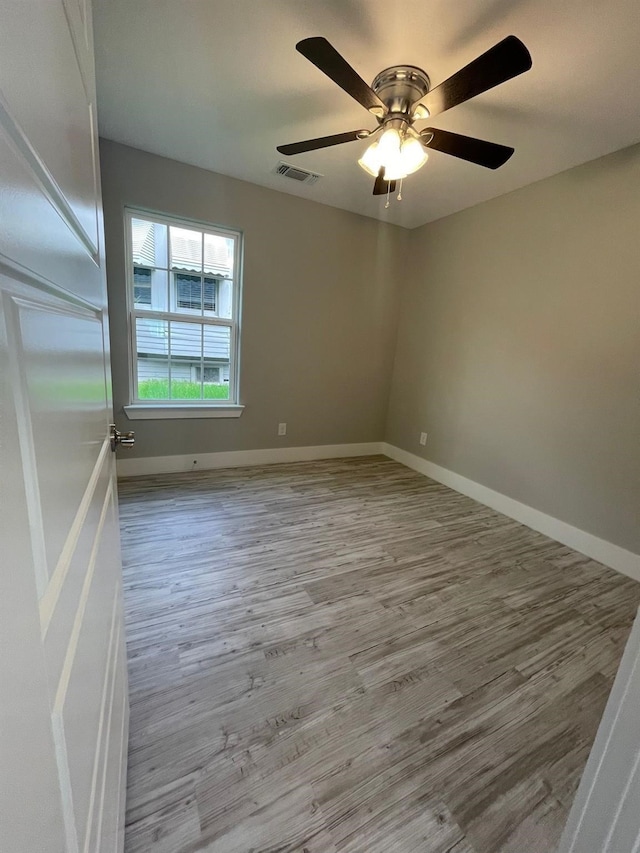 1315 W Gandy St, Denison, TX 75020 - unfurnished room featuring wood finished floors, baseboards, and a ceiling fan