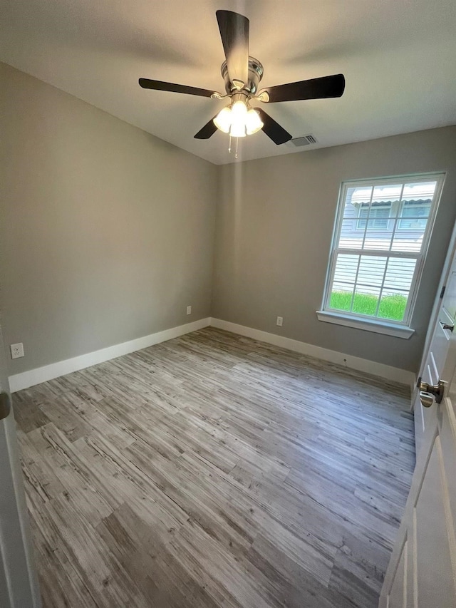 1315 W Gandy St, Denison, TX 75020 - unfurnished room featuring wood finished floors, ceiling fan, and baseboards