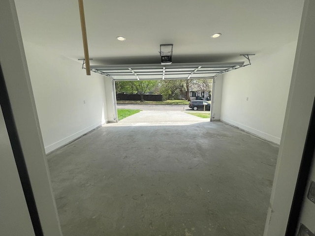 1315 W Gandy St, Denison, TX 75020 - garage featuring a garage door opener, baseboards, and recessed lighting