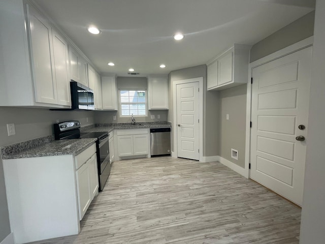 1315 W Gandy St, Denison, TX 75020 - kitchen featuring stainless steel appliances, a sink, light wood-style floors, white cabinetry, and recessed lighting