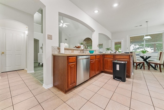 7804 Rampston Pl, Fort Worth, TX 76137 - kitchen with dishwasher, brown cabinets, light tile patterned floors, light countertops, and ceiling fan