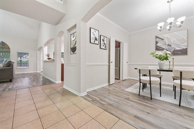 7804 Rampston Pl, Fort Worth, TX 76137 - dining room featuring wood finished floors, arched walkways, a chandelier, crown molding, and baseboards