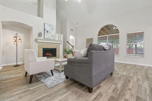 7804 Rampston Pl, Fort Worth, TX 76137 - living area featuring wood finished floors, a tile fireplace, high vaulted ceiling, ceiling fan, and baseboards