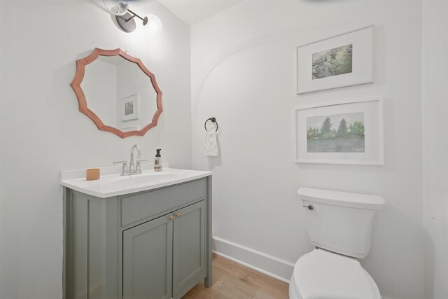 2006 Country Oaks Dr, Garland, TX 75040 - half bath featuring vanity and wood finished floors